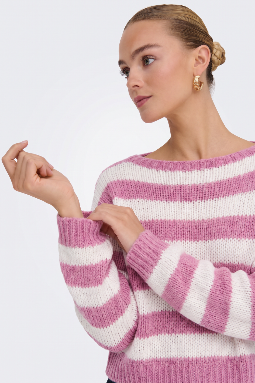 Pink striped chunky knit jumper sleeve and cuff detail, on model