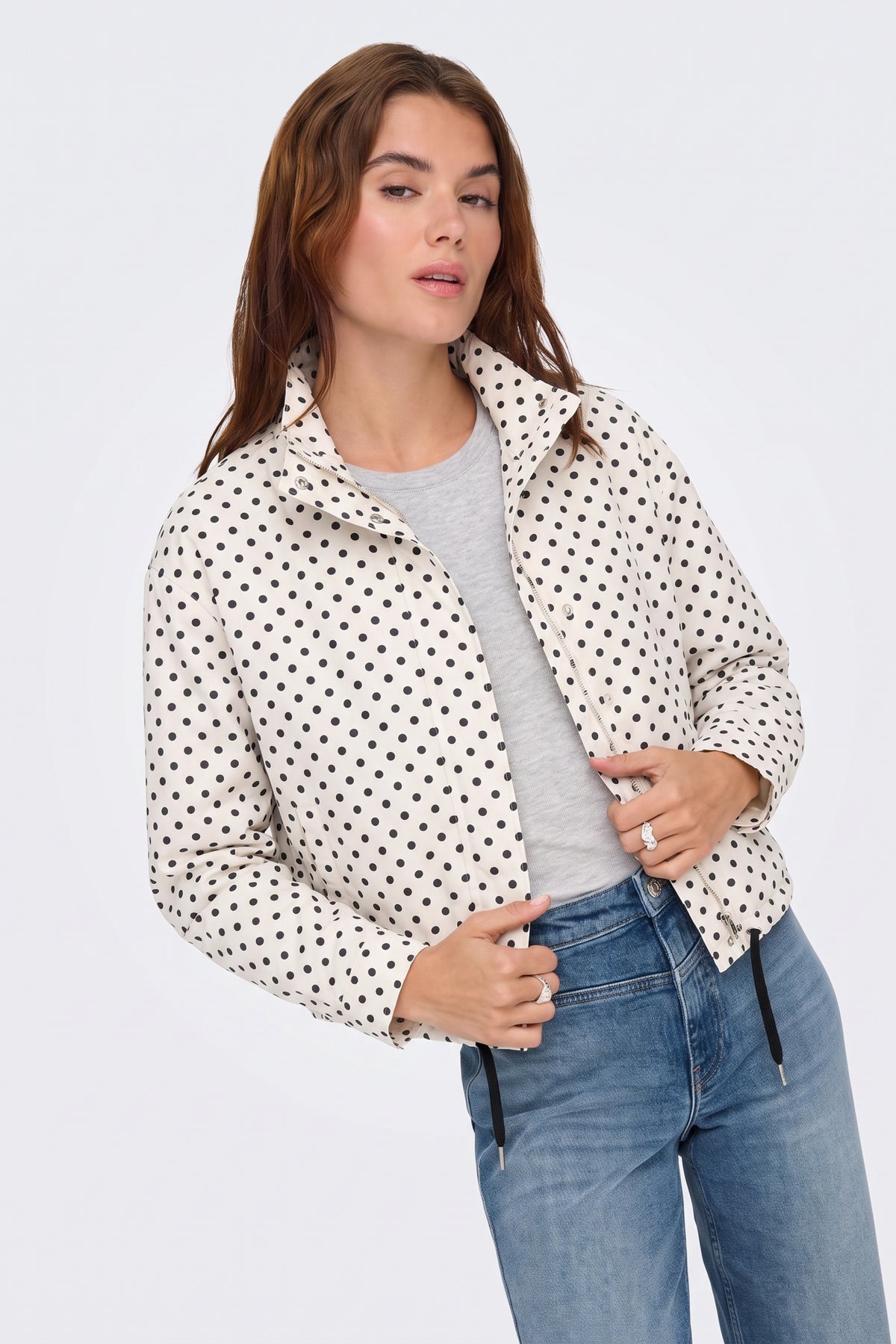 Cream polka dot jacket worn open over a grey tee, on model