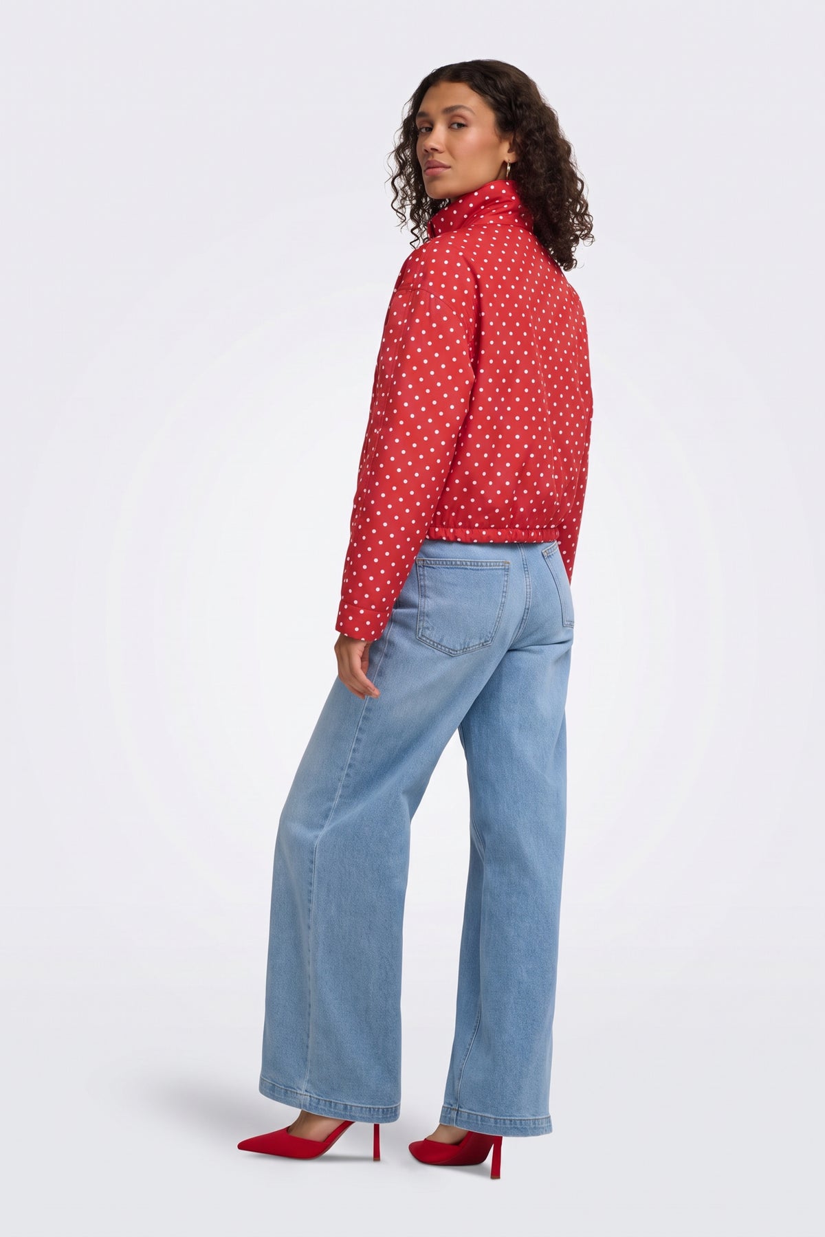 Red polka dot puffer jacket back view on model
