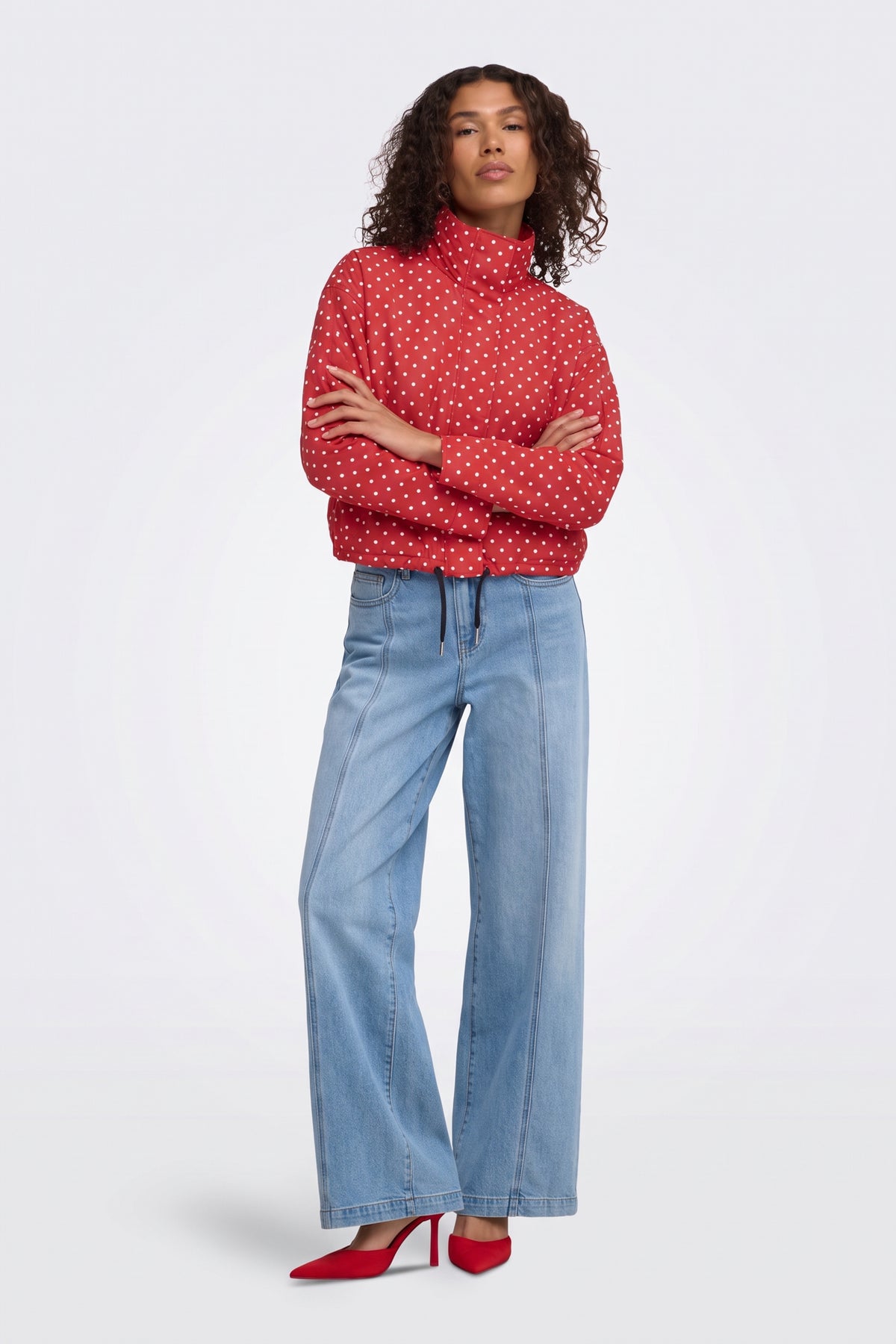 Red polka dot cropped puffer jacket, full length on model