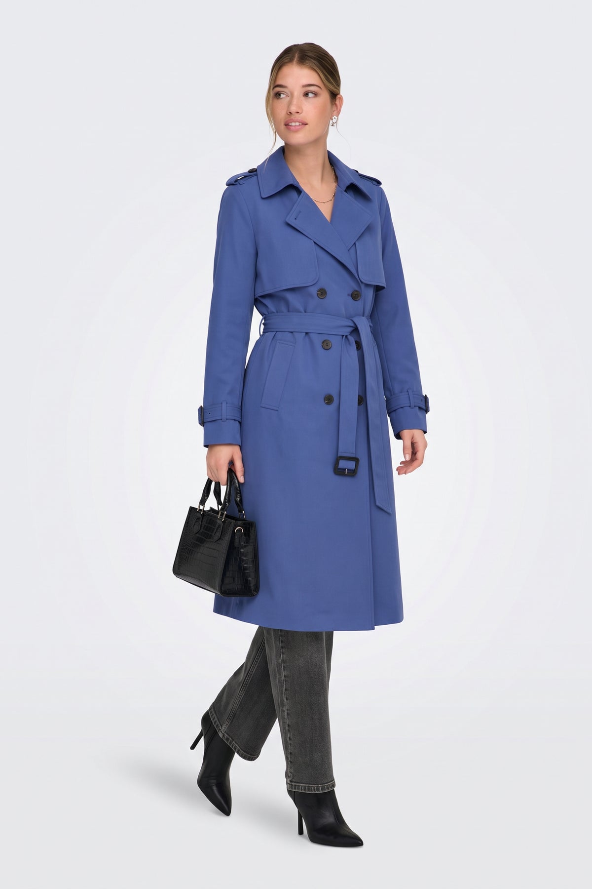Blue long trench coat side view on model