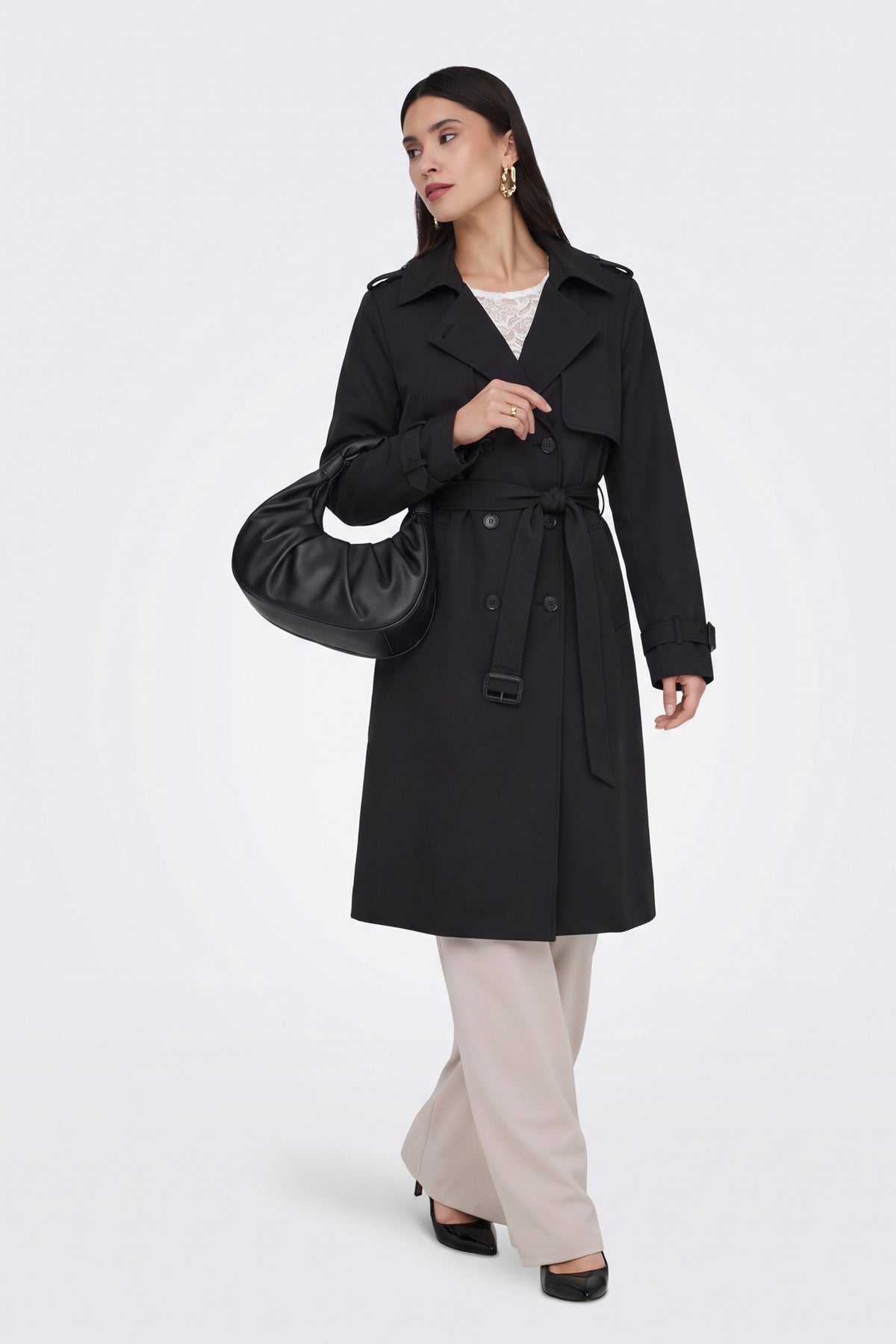 Black long trench coat worn belted at the waist