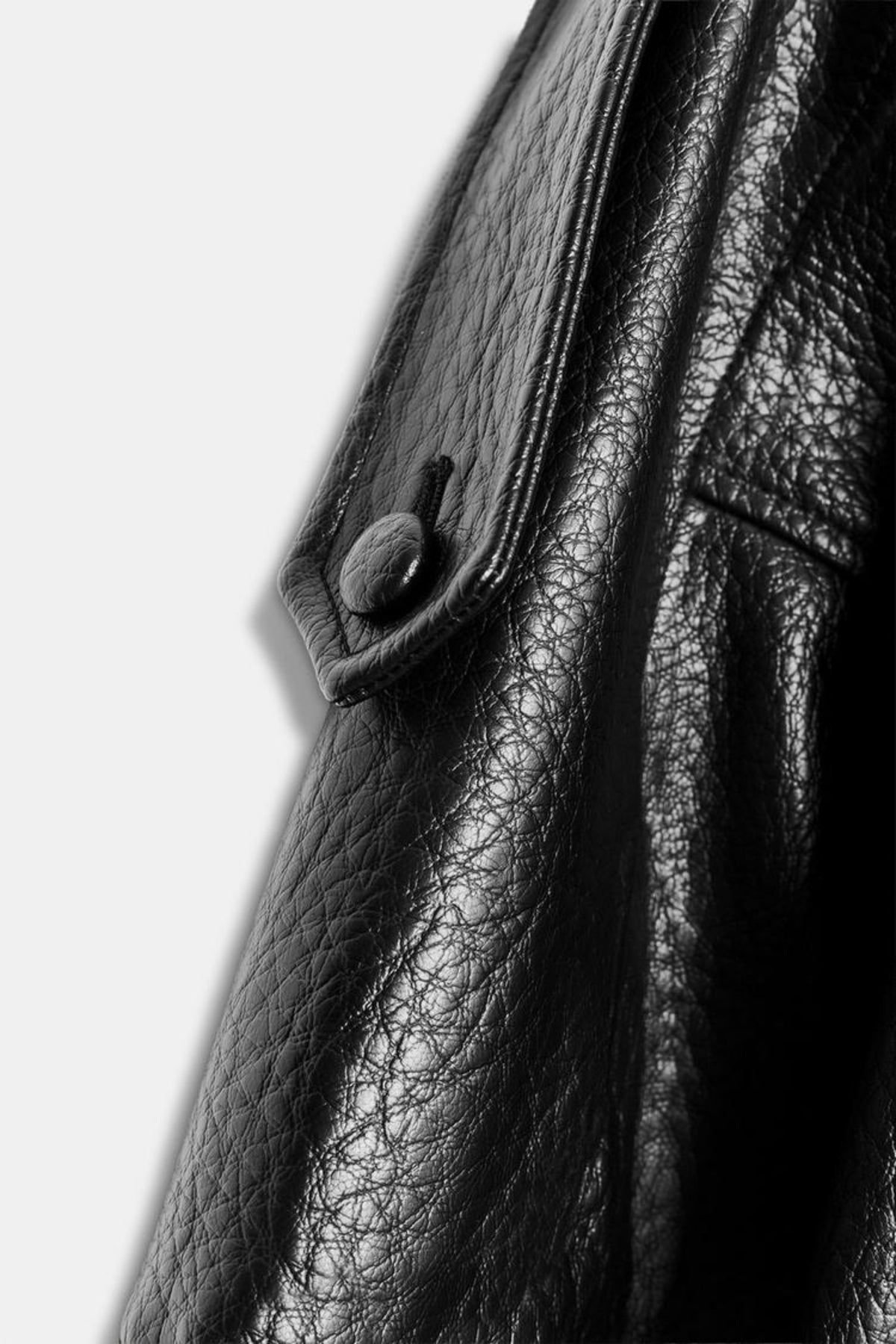 Black faux leather jacket grained texture and button detail