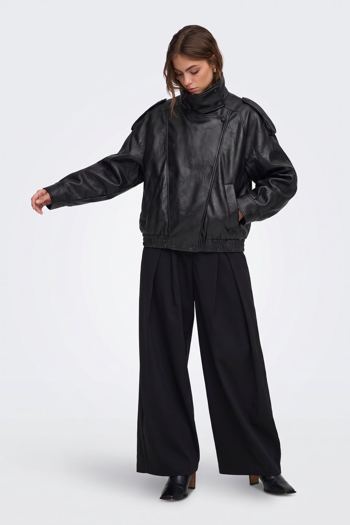 Black faux leather funnel neck jacket with wide-leg trousers, full length