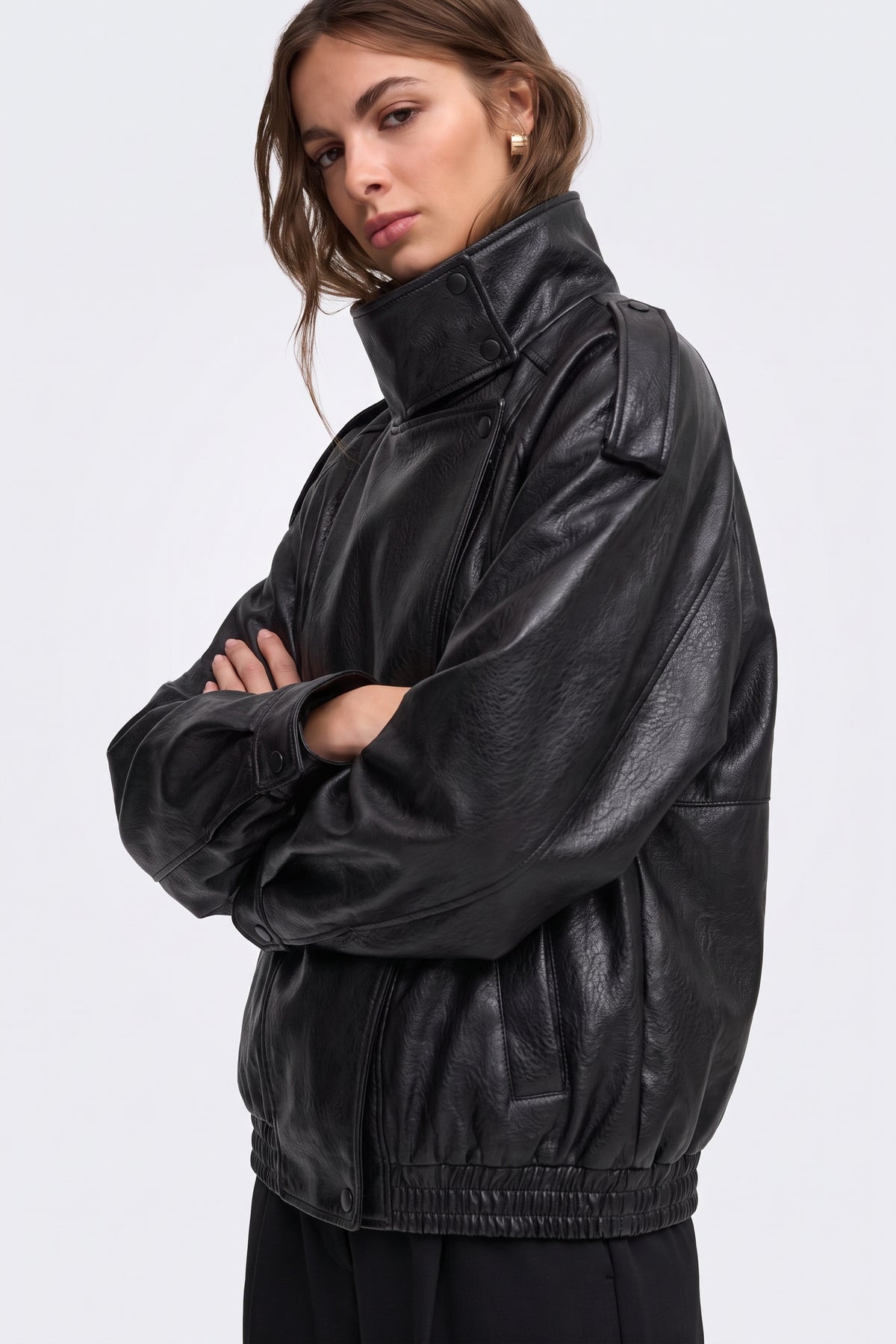 Black faux leather jacket funnel collar and epaulette, side view on model