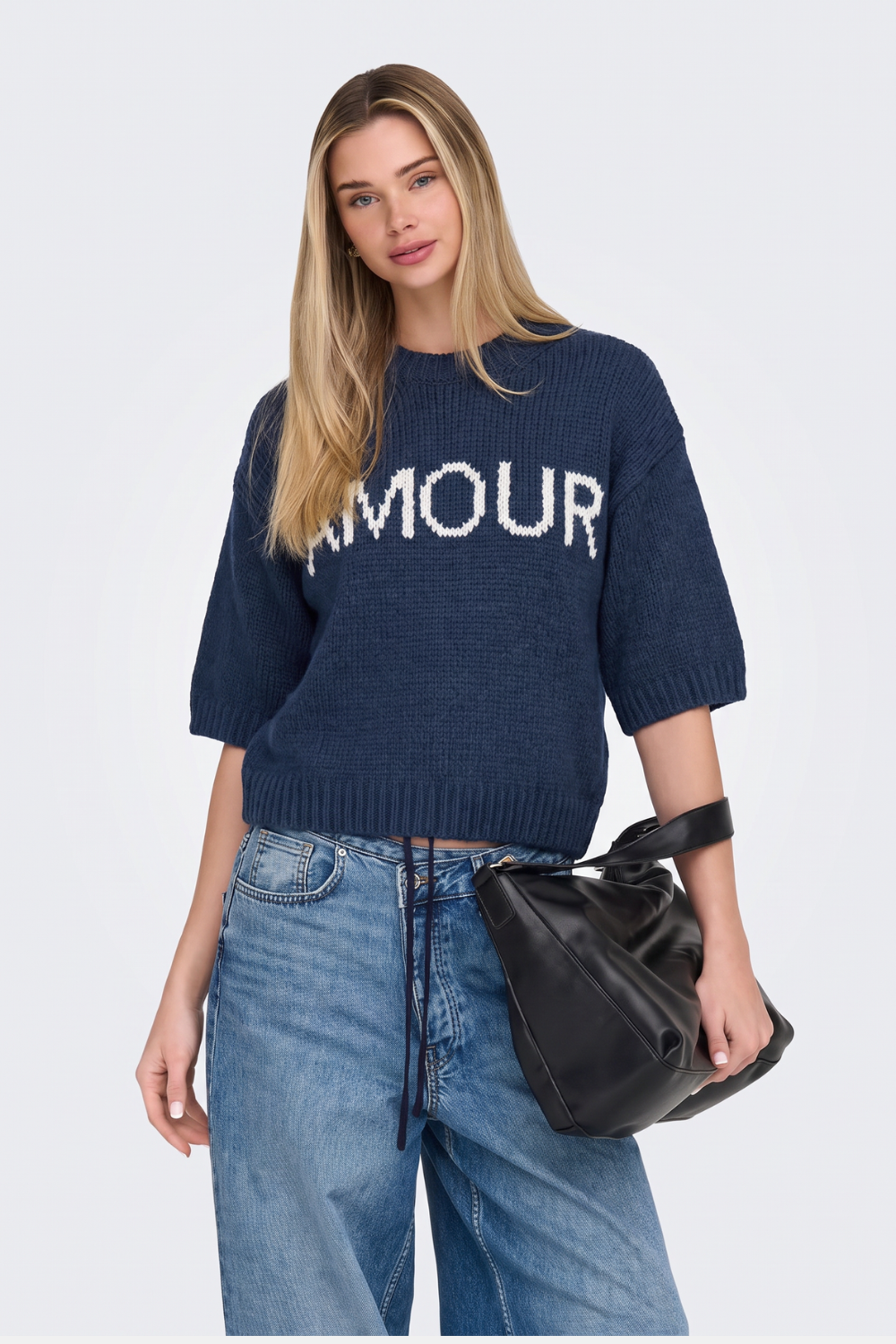 Navy short sleeve knitted jumper with Amour slogan and jeans, on model