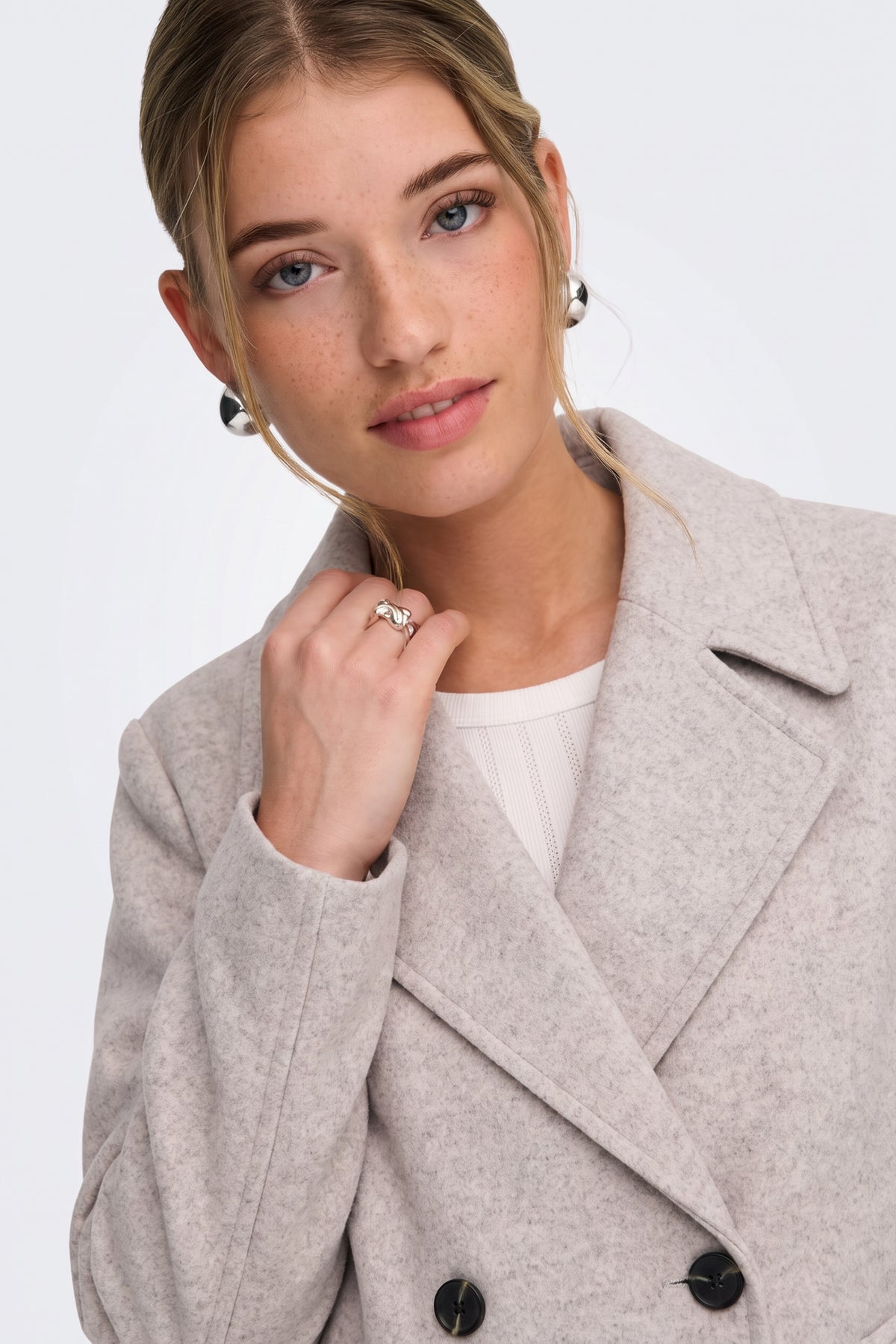 Light grey coat notched lapel close-up, on model