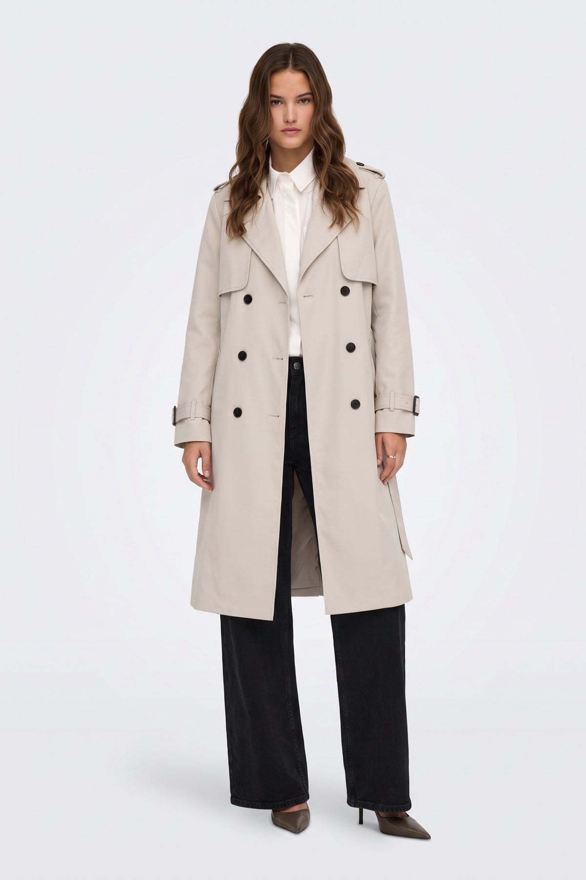 Cream long trench coat worn belted at the waist