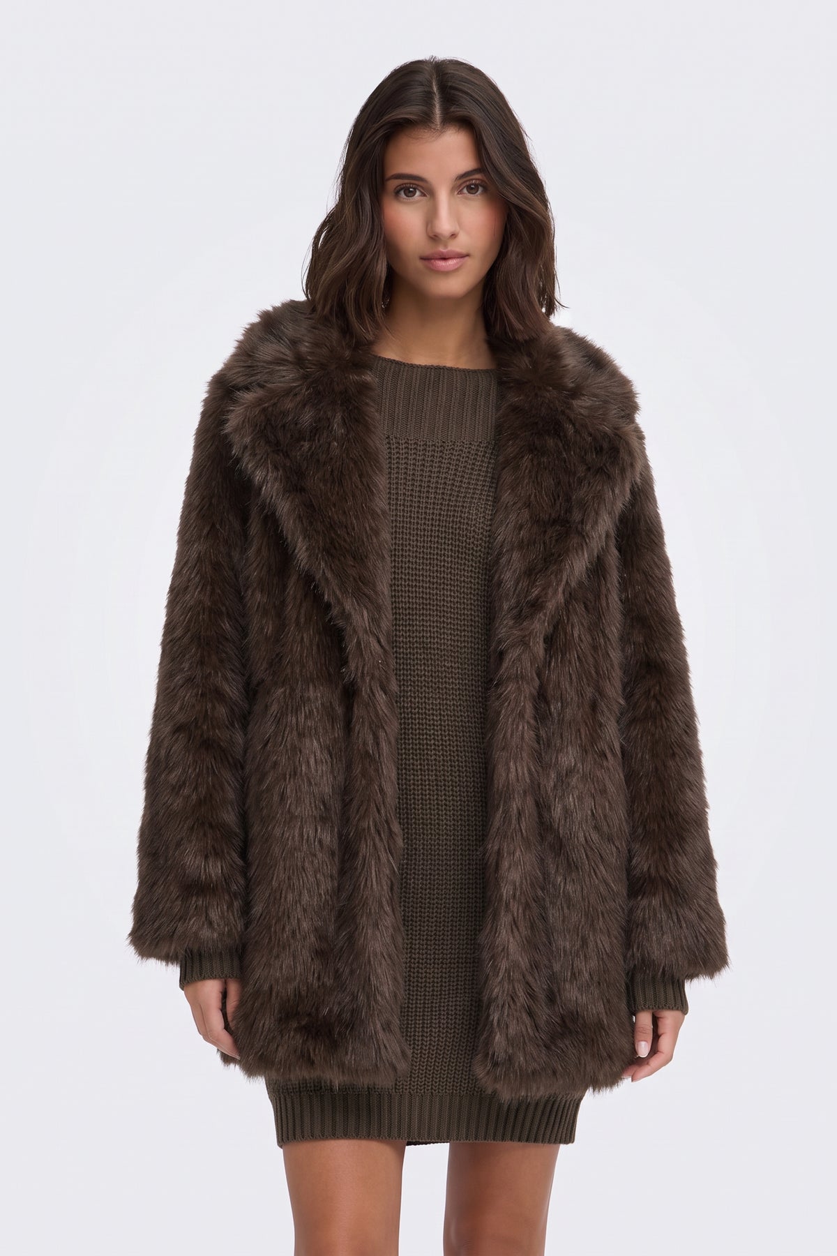 Brown faux fur coat worn open over a black outfit