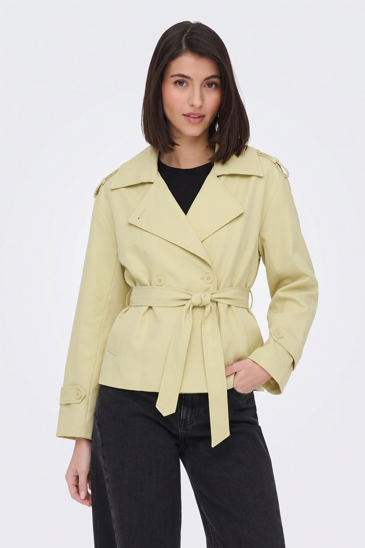 Yellow short belted trench jacket on model, front view
