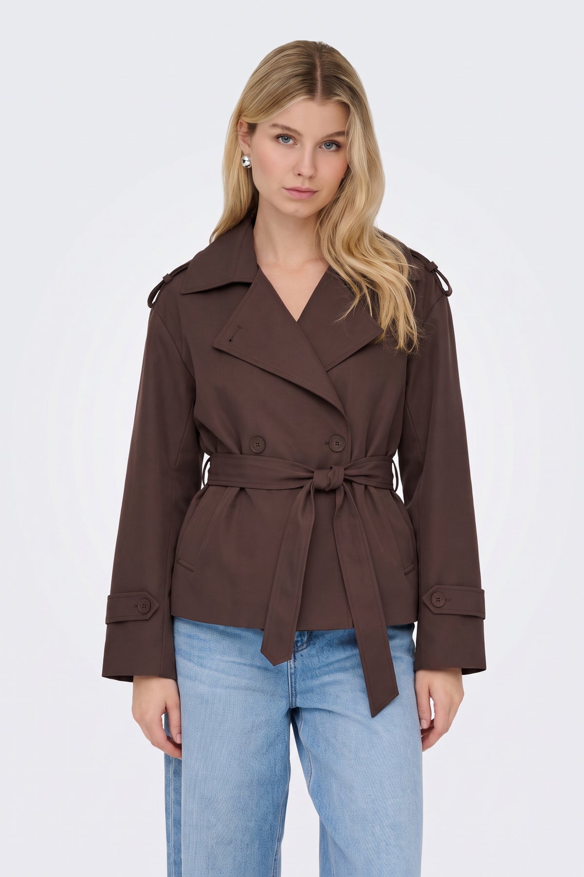 Brown short belted trench jacket on model, front view
