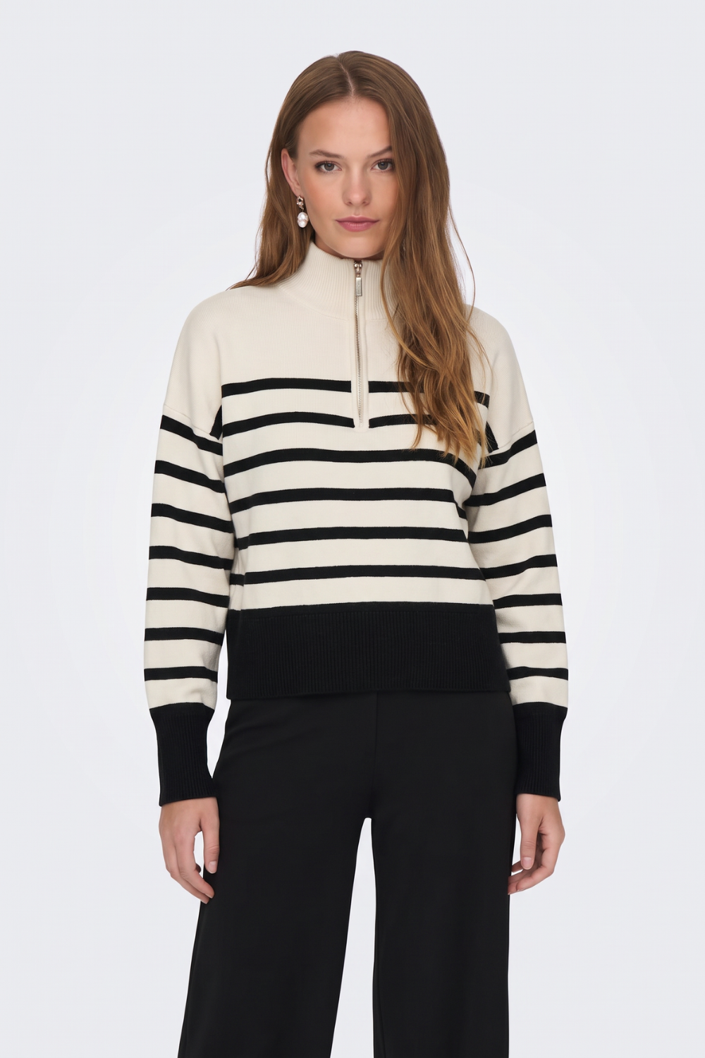 Cream and black striped half zip jumper with black trousers, on model