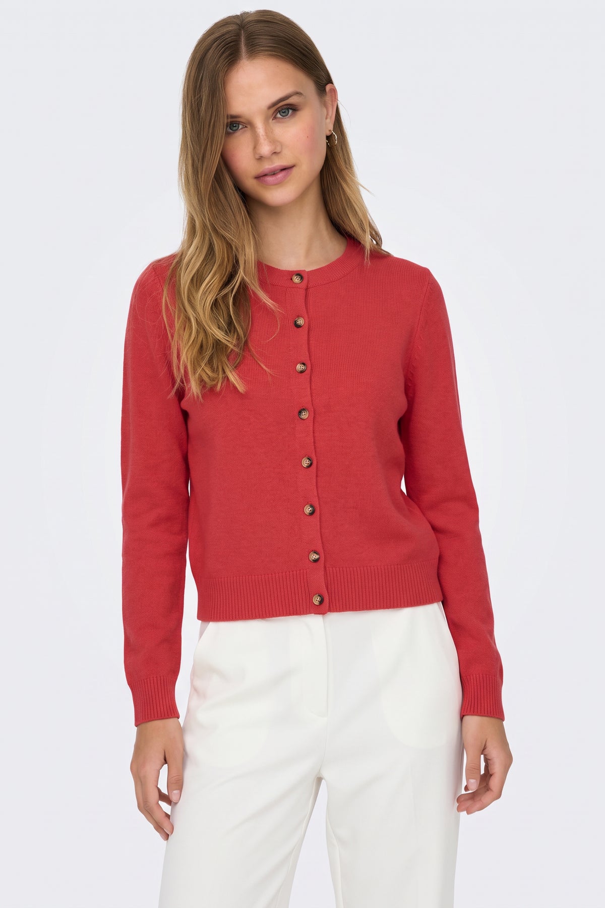 Red piece styled with denim on model