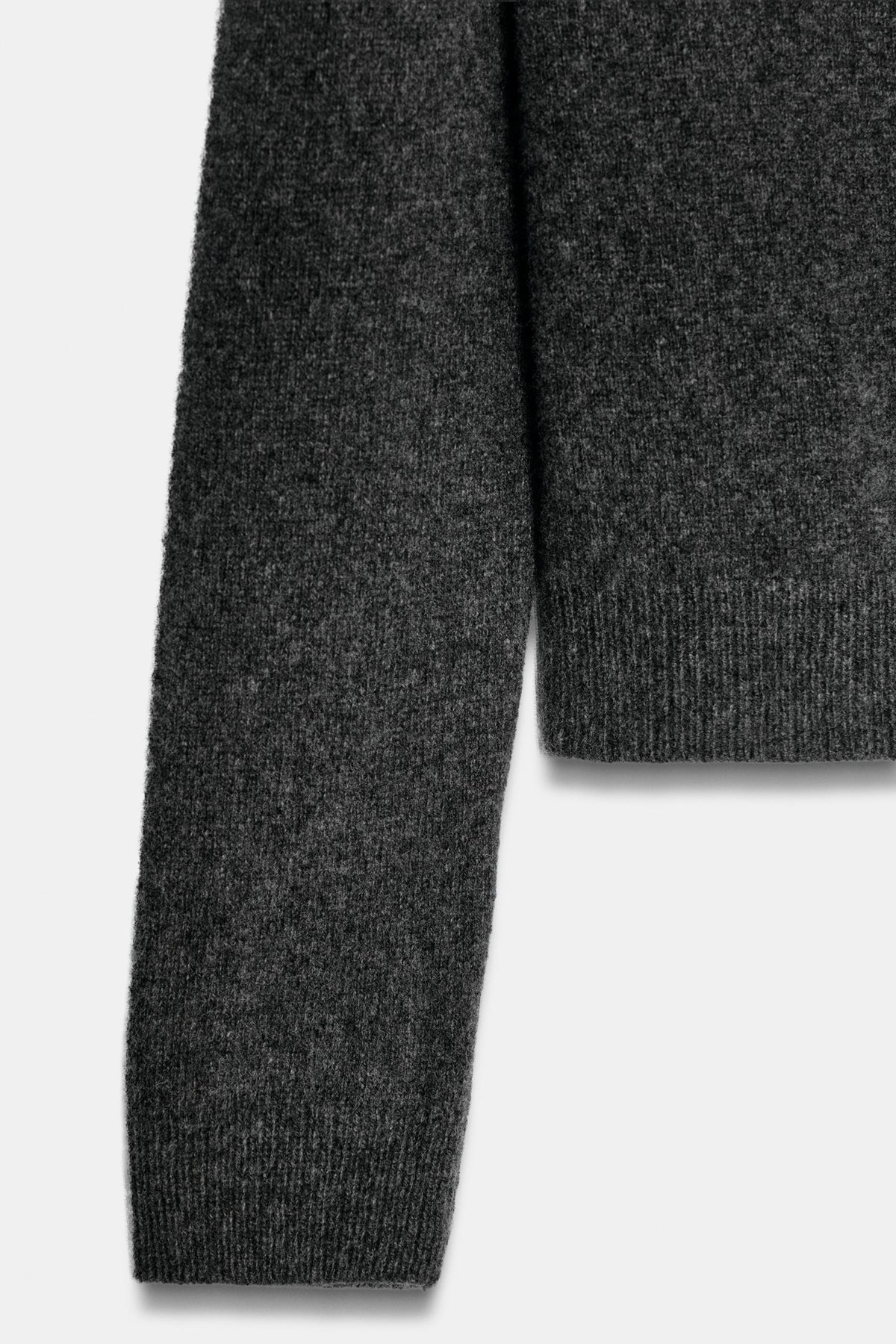 Charcoal knit fabric and sleeve detail close up