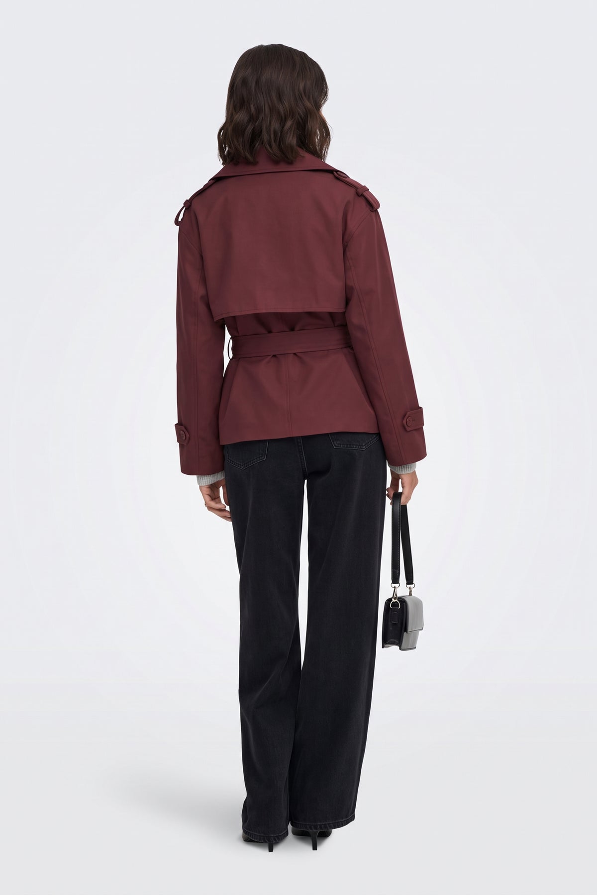 Burgundy short trench jacket back view with storm flap