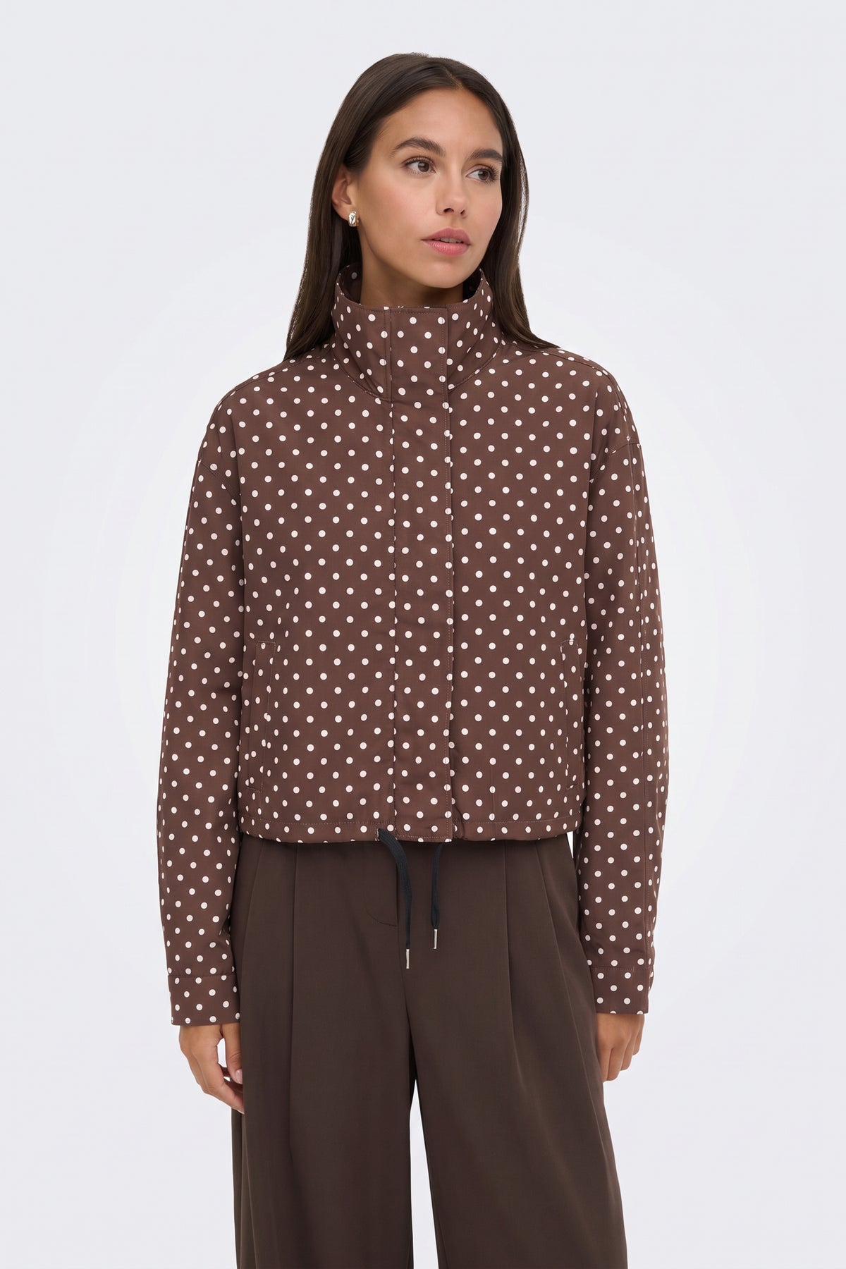 Brown polka dot puffer jacket with brown wide-leg trousers, on model