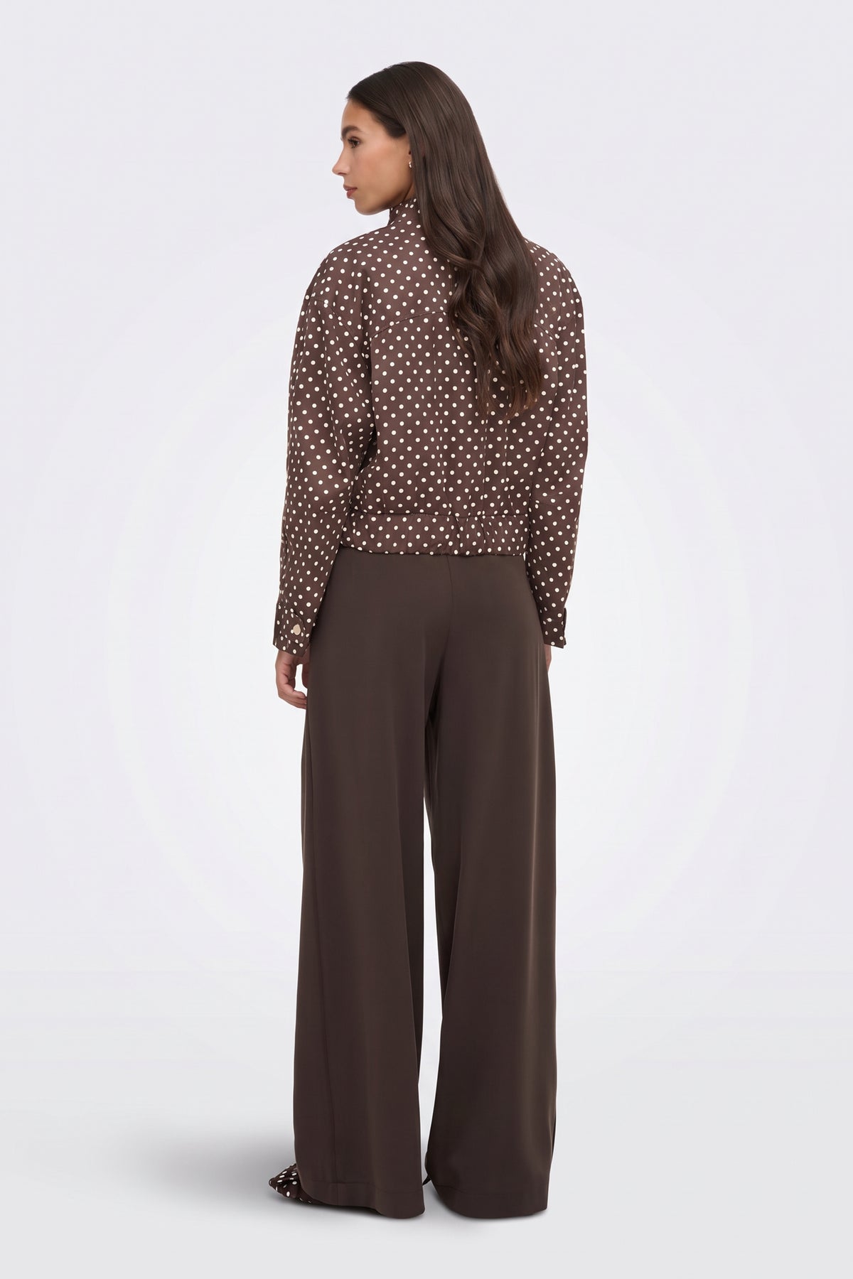Brown polka dot puffer jacket back view on model