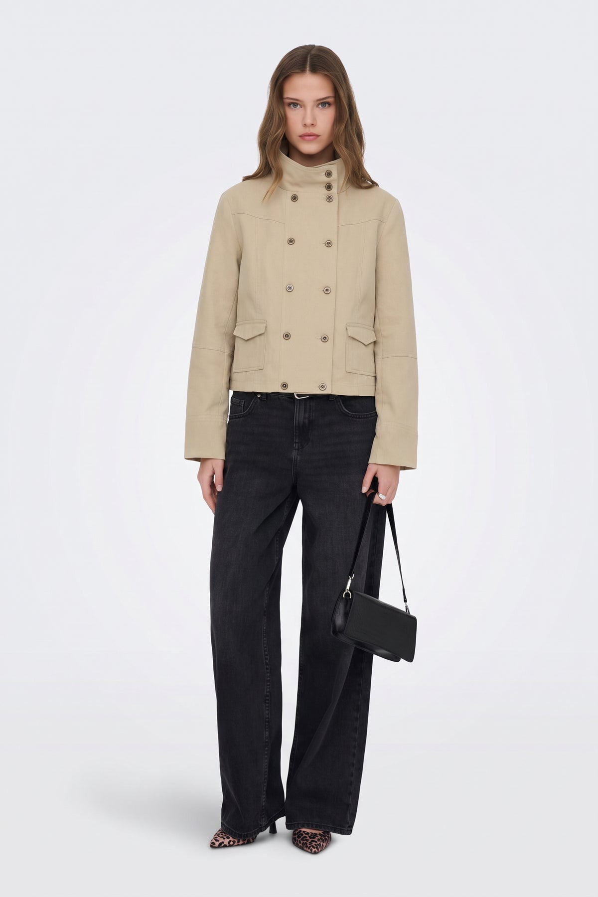 Beige cropped utility jacket on model with wide-leg jeans
