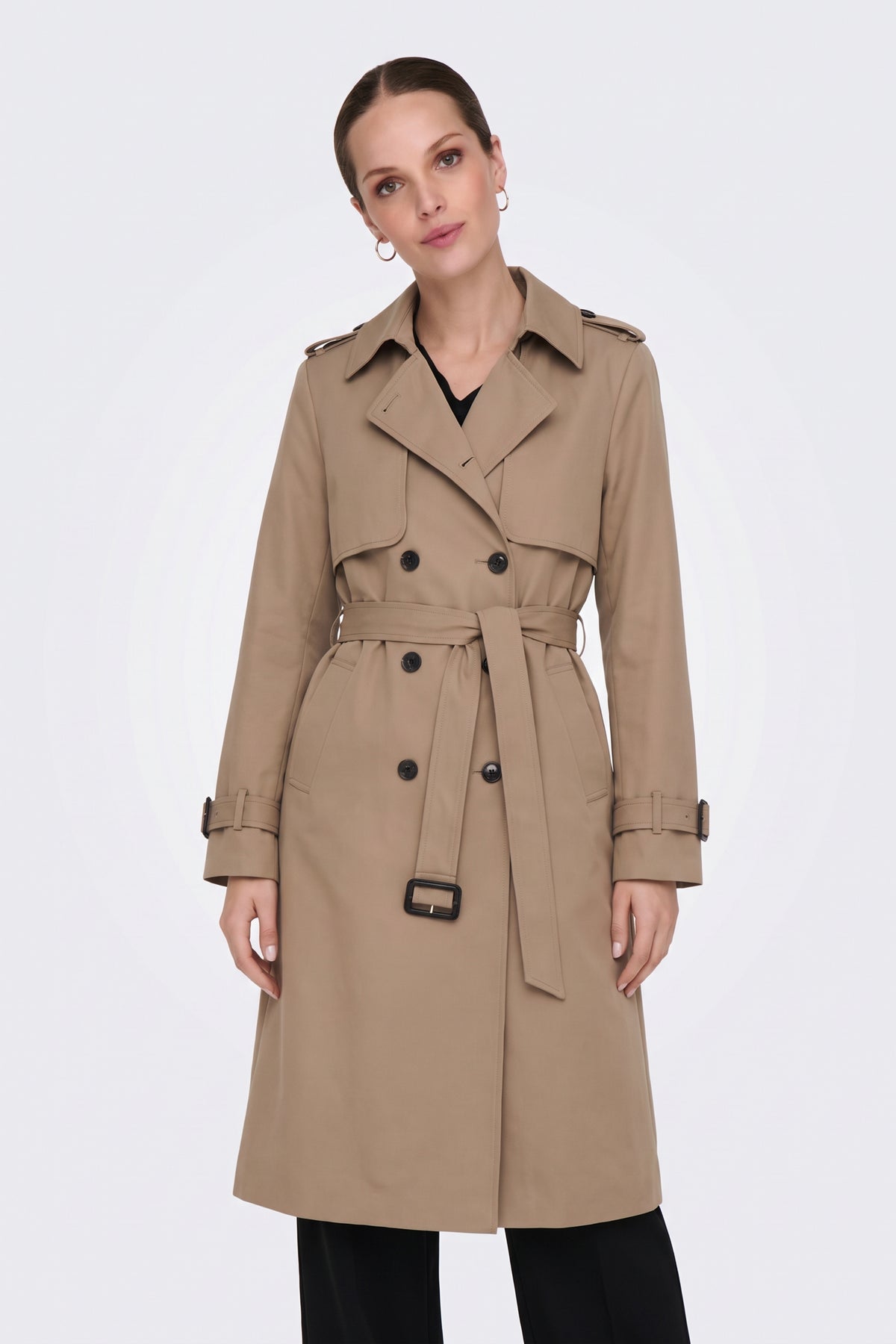 Camel belted trench coat on model, front view