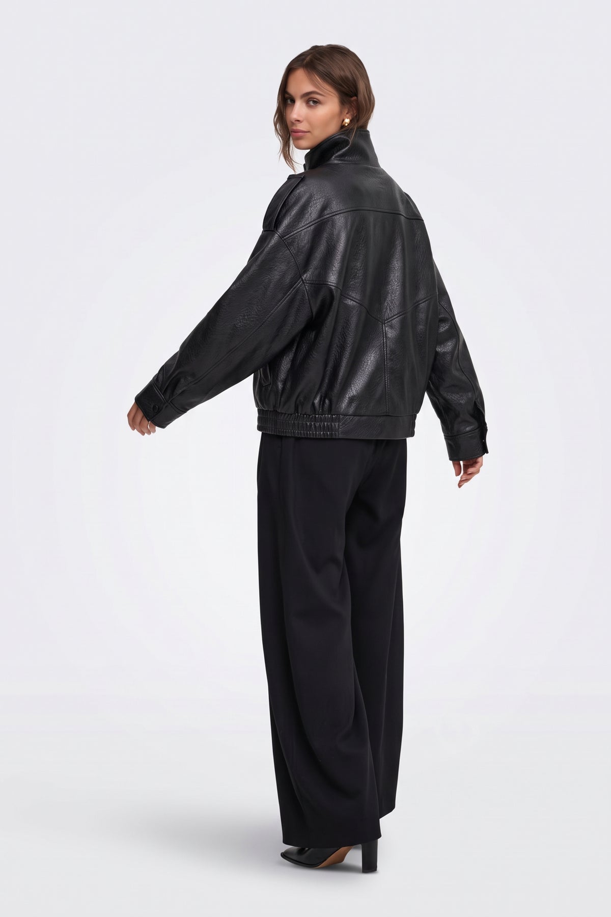 Black faux leather funnel neck jacket, back view on model