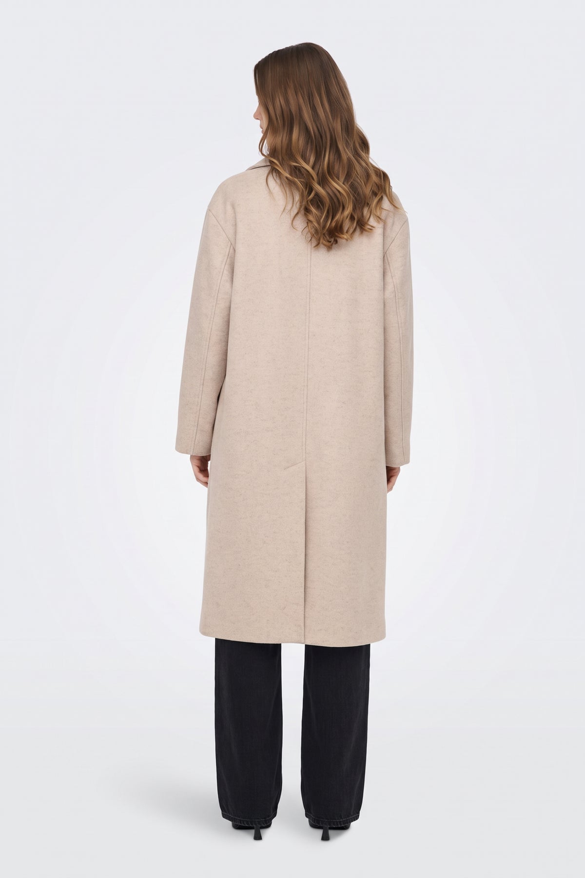 Long beige coat back view with back vent, on model