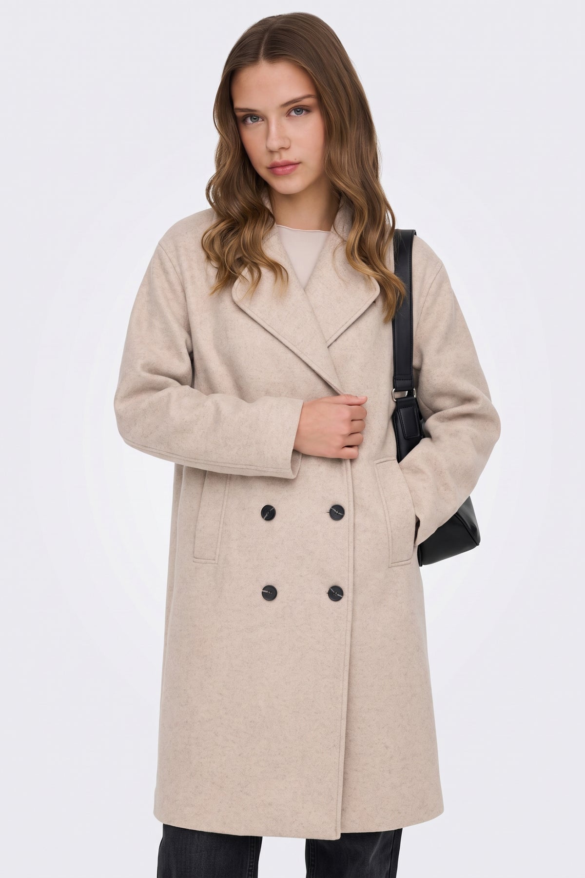 Beige double-breasted coat with notched lapels, close-up on model