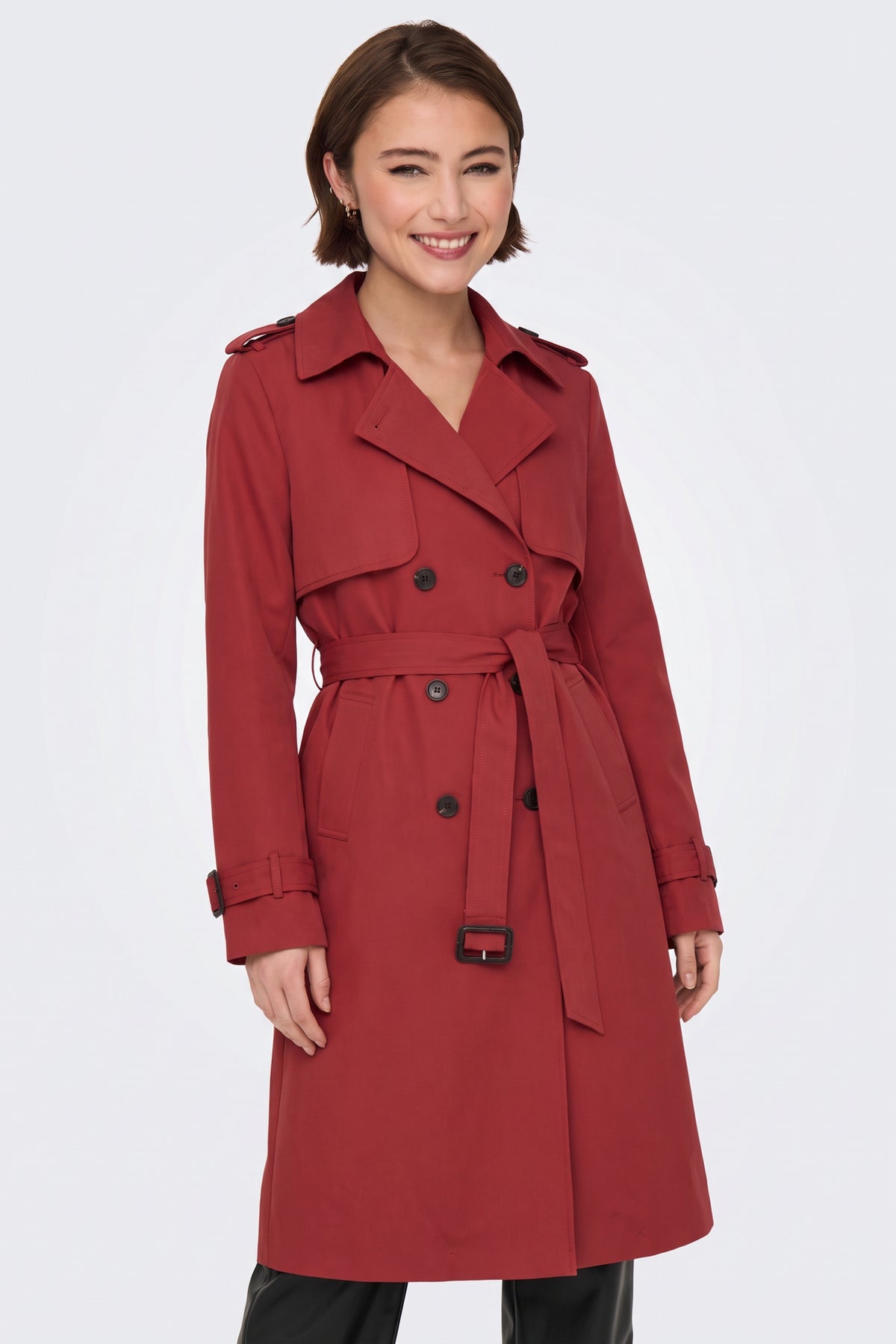Red long trench coat worn belted at the waist