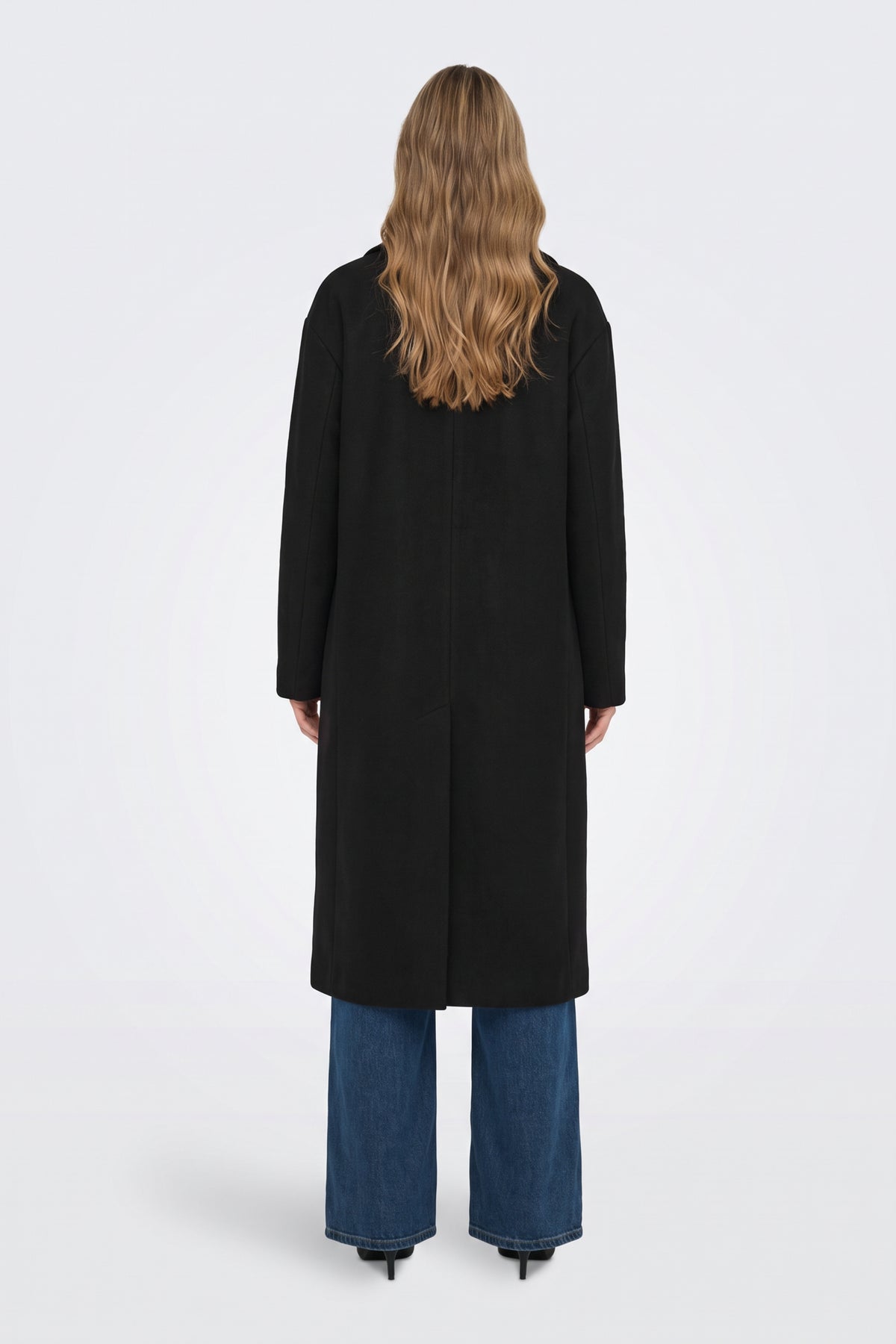 Long black coat back view with back vent, on model