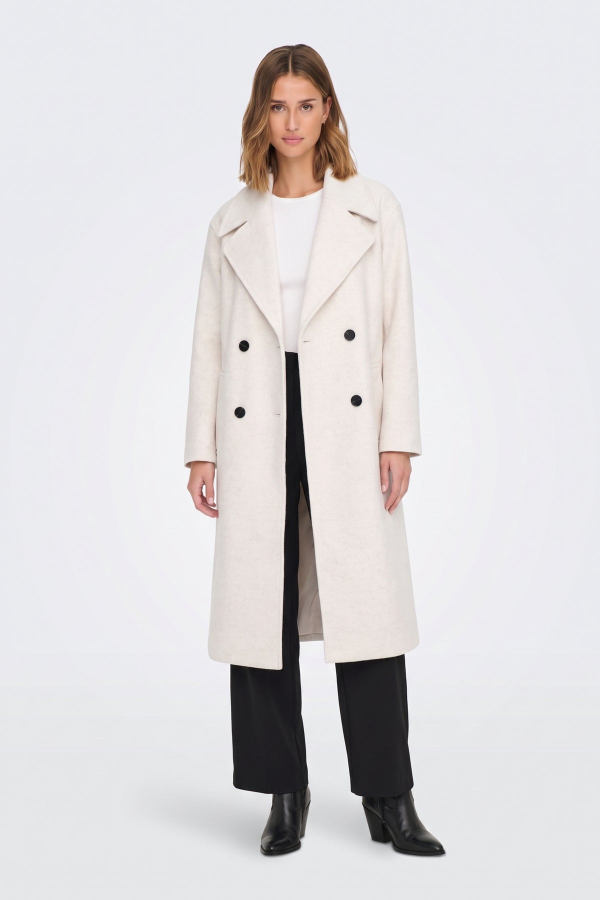 Cream long coat with notched lapels and ankle boots, on model