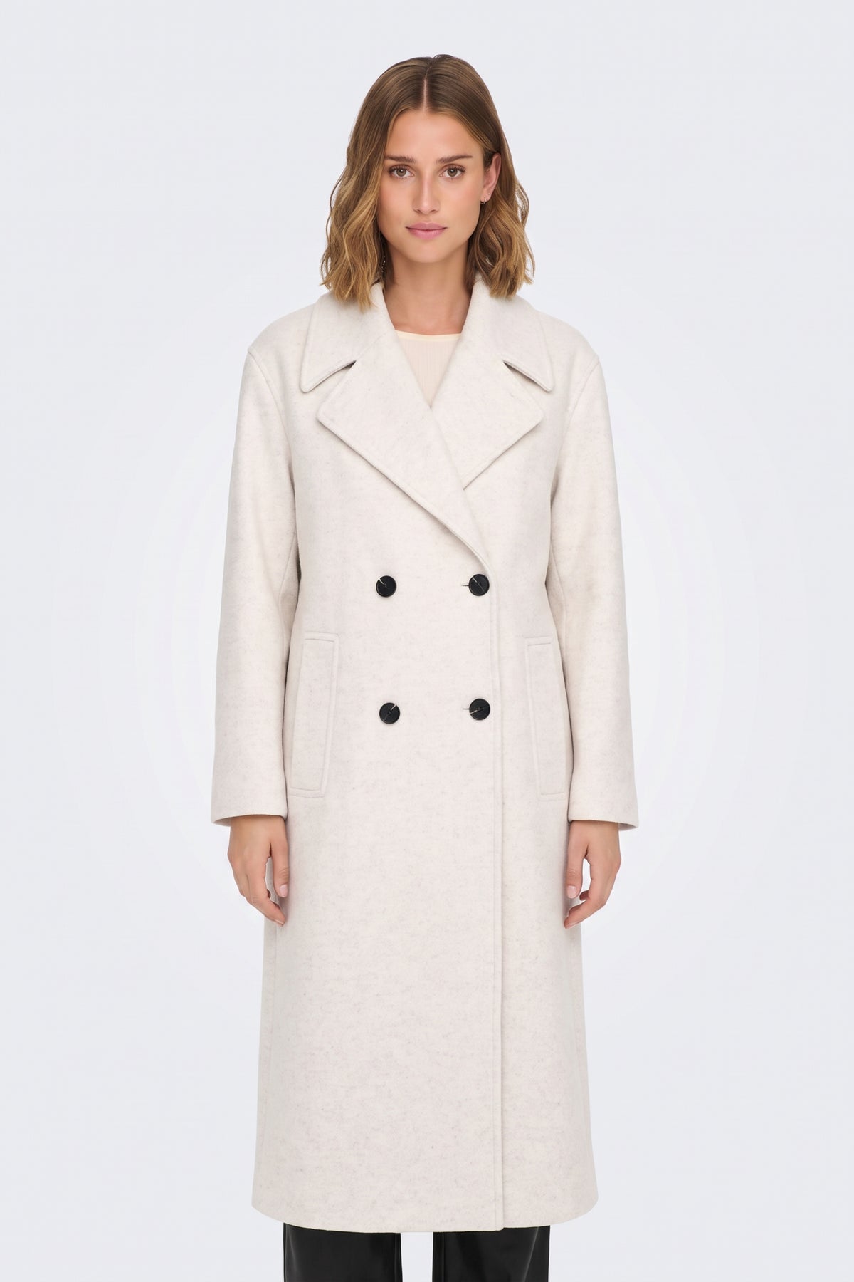 Long cream double-breasted coat with black buttons, on model
