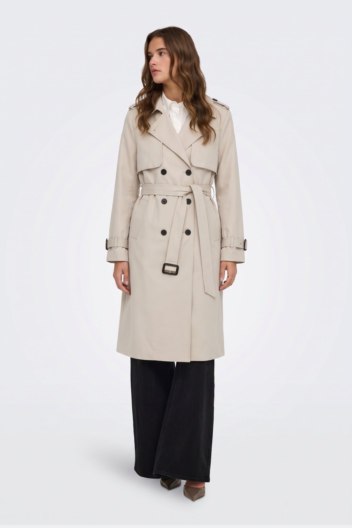 Cream belted trench coat on model, front view