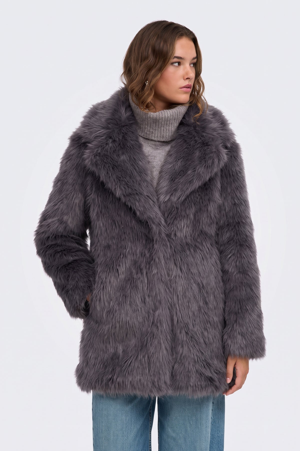 Grey faux fur coat worn open over a black outfit