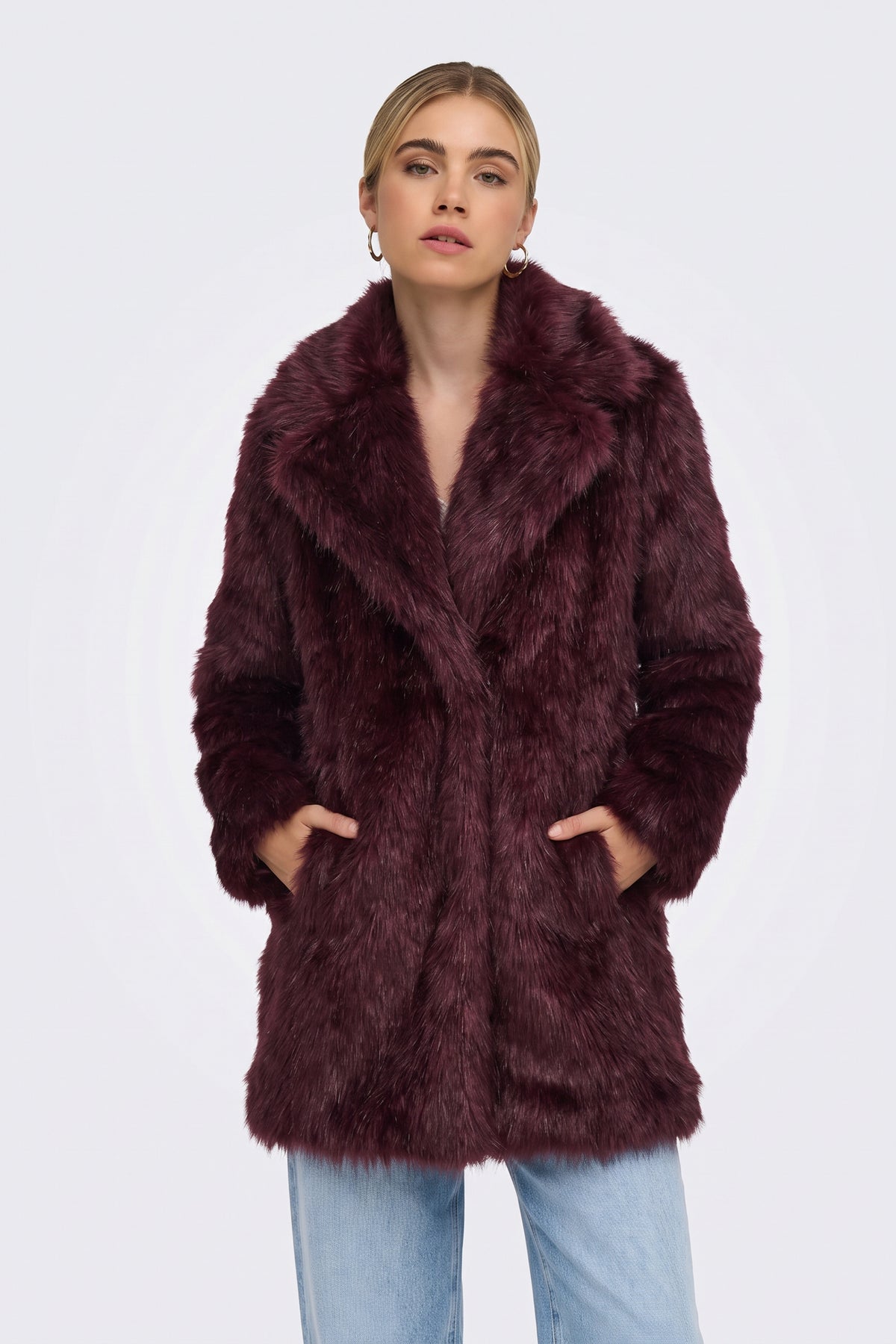 Burgundy faux fur coat worn open over a black outfit