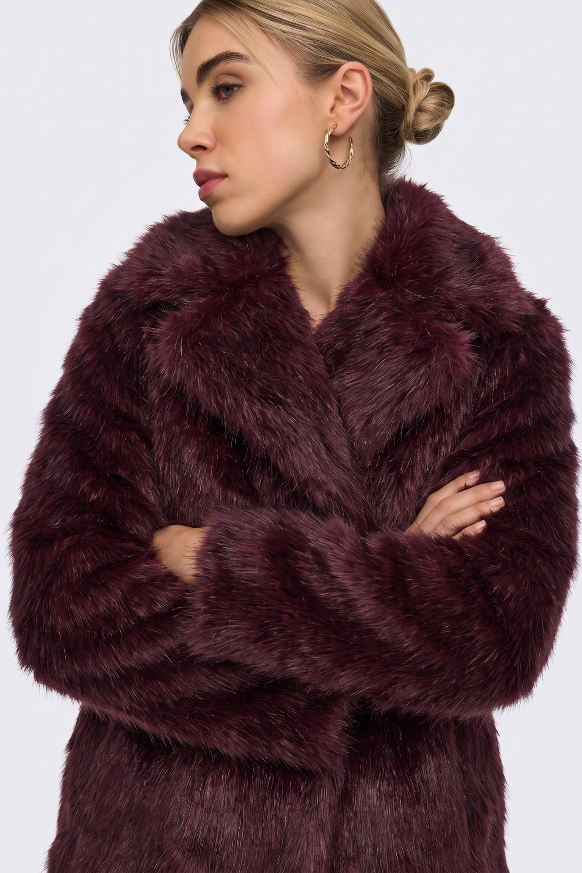 Burgundy longline faux fur coat on model, front view