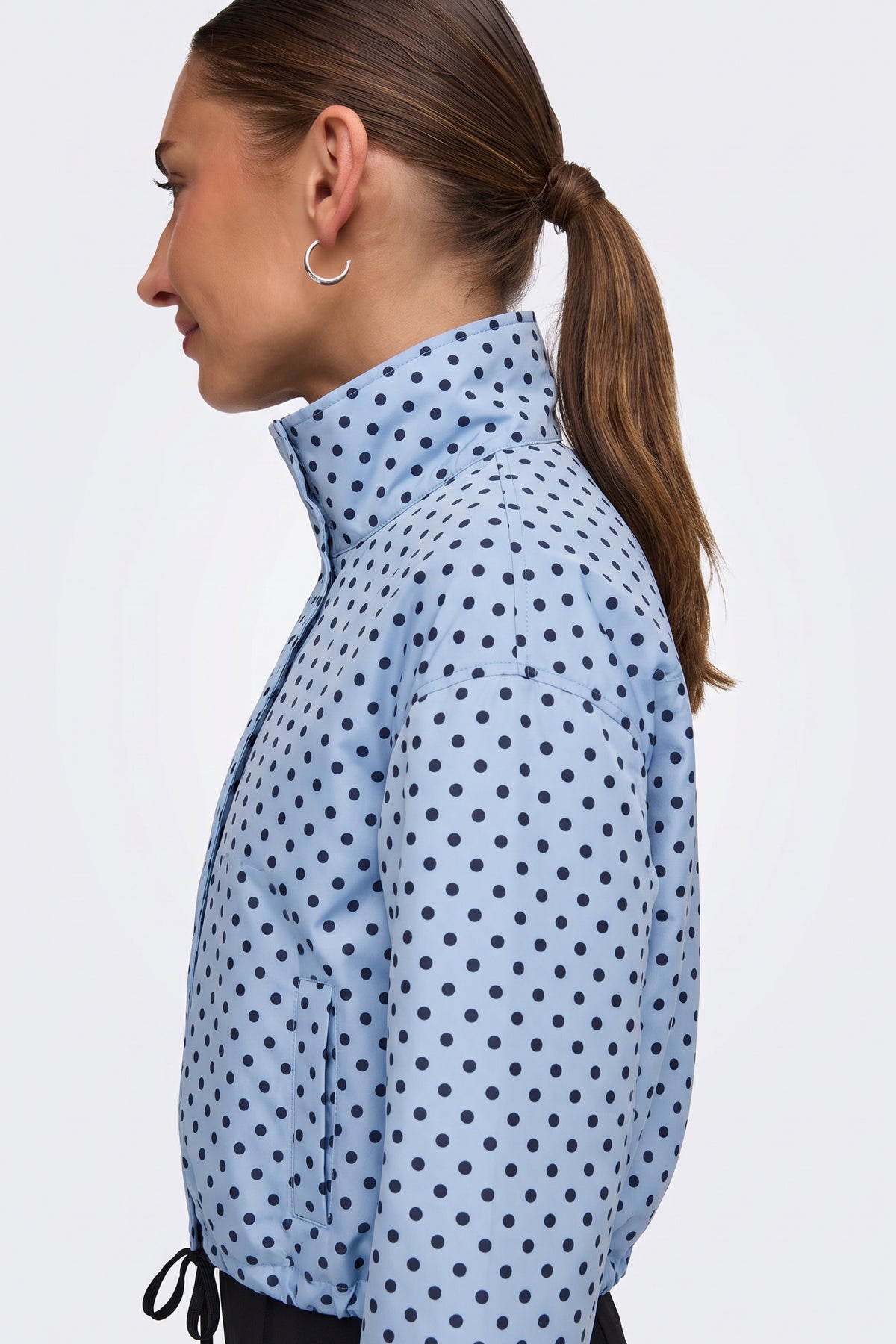 Light blue polka dot puffer jacket side view on model