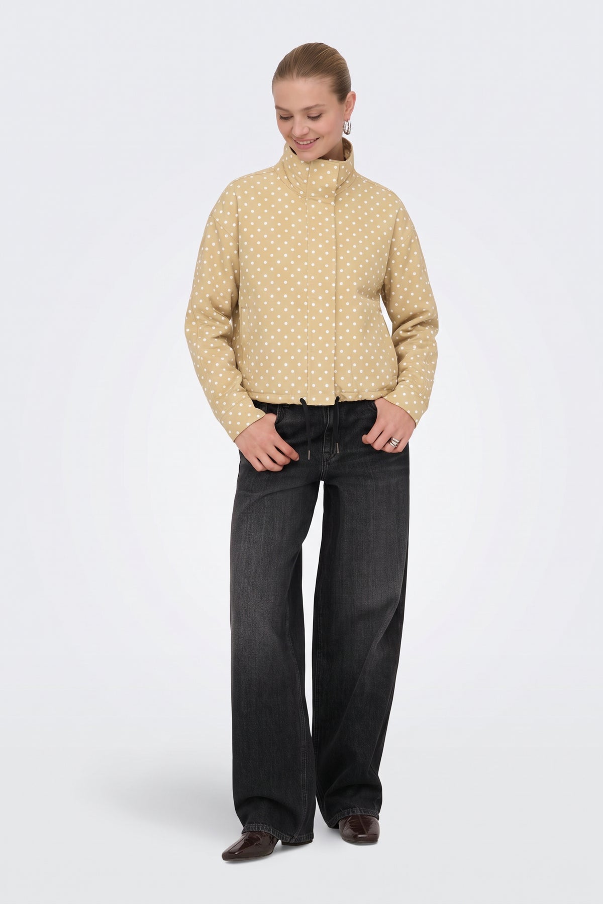 Yellow polka dot puffer jacket, full length on model