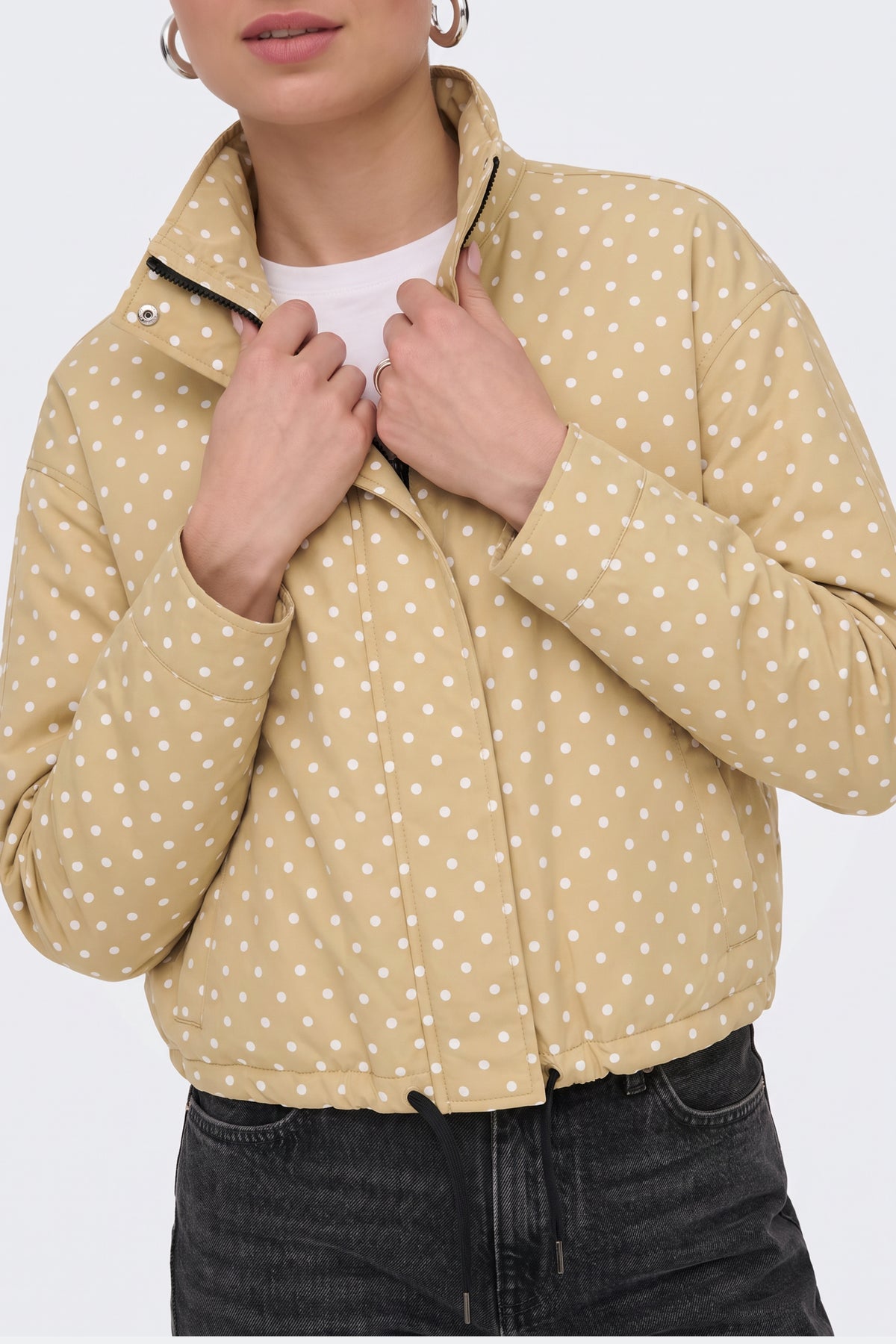 Yellow polka dot puffer jacket zip and collar detail