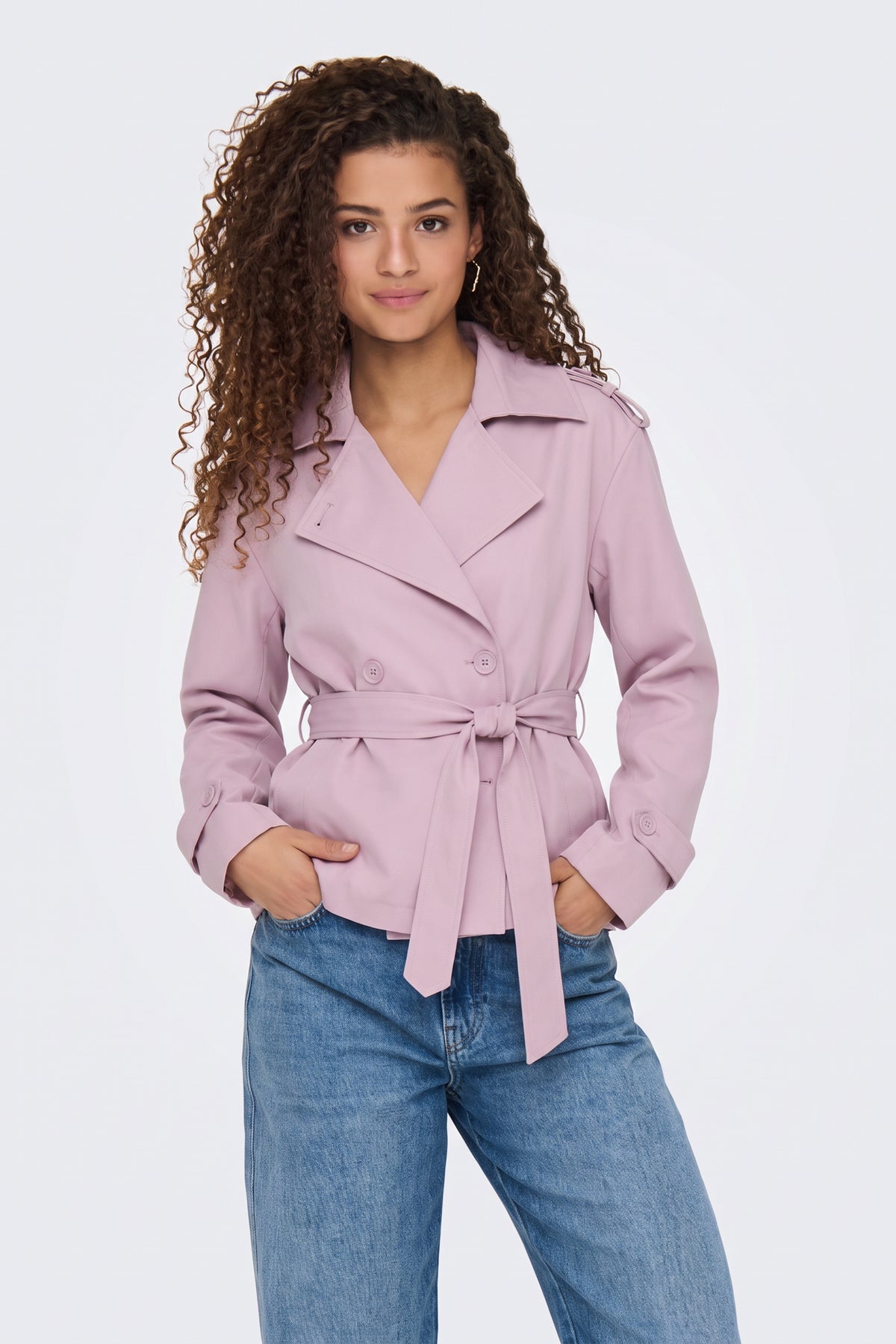 Pink short belted trench jacket on model, front view