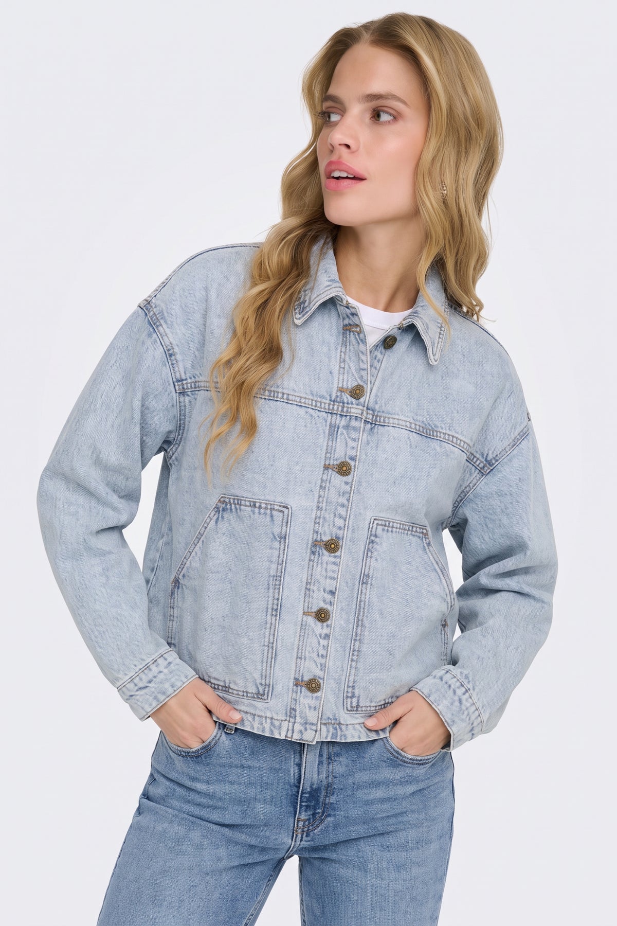 Light blue washed denim jacket with patch pockets, on model