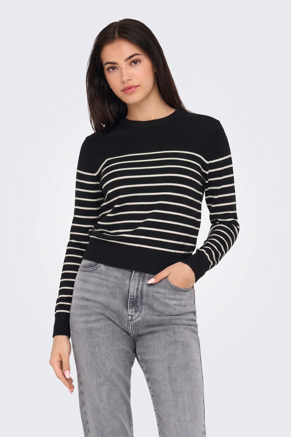 Black and cream breton striped jumper with grey jeans, on model