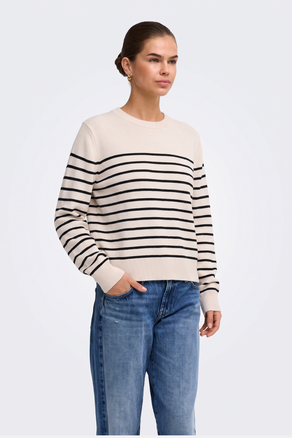 Cream and black breton striped jumper with blue jeans, on model