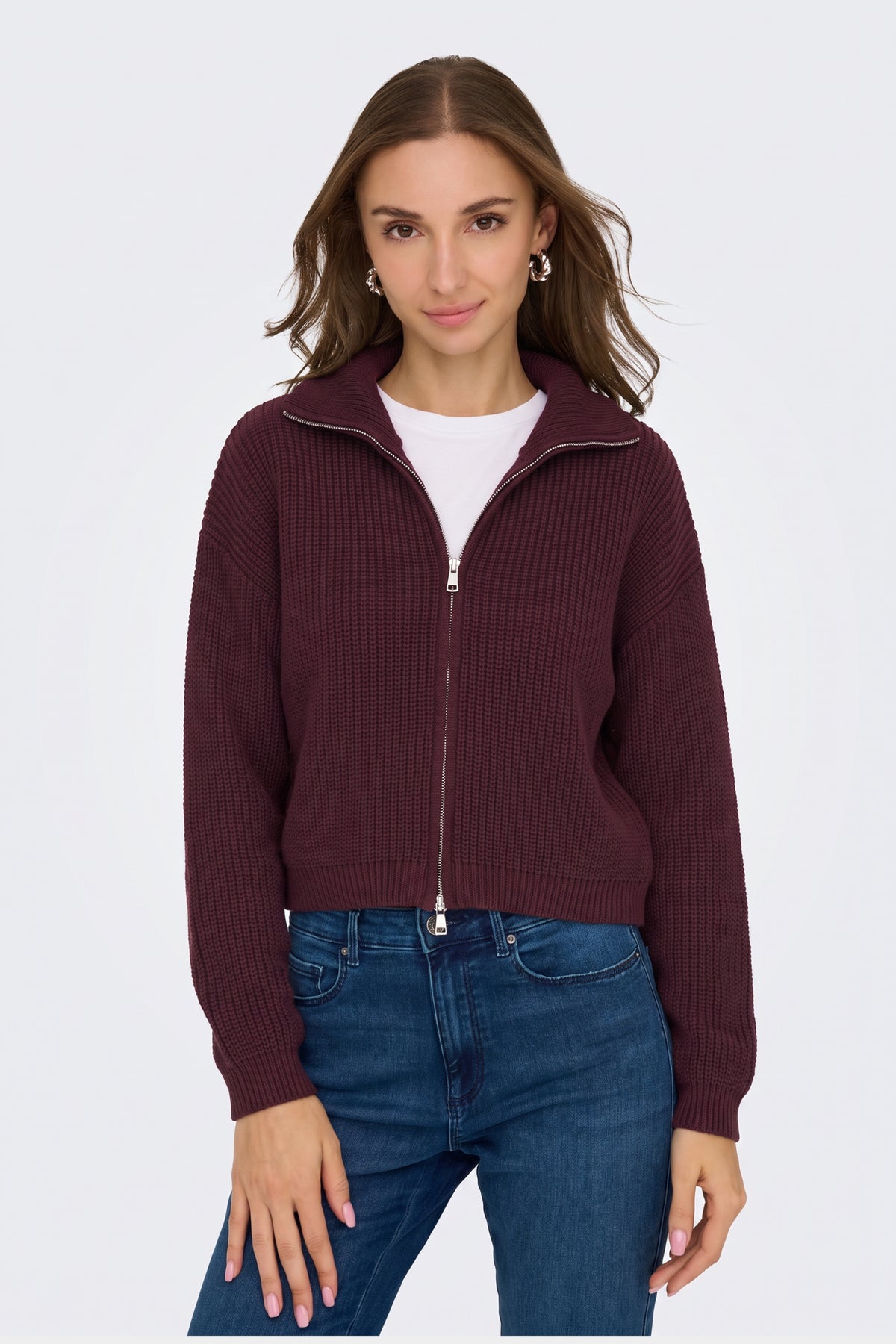 Burgundy piece styled with denim on model